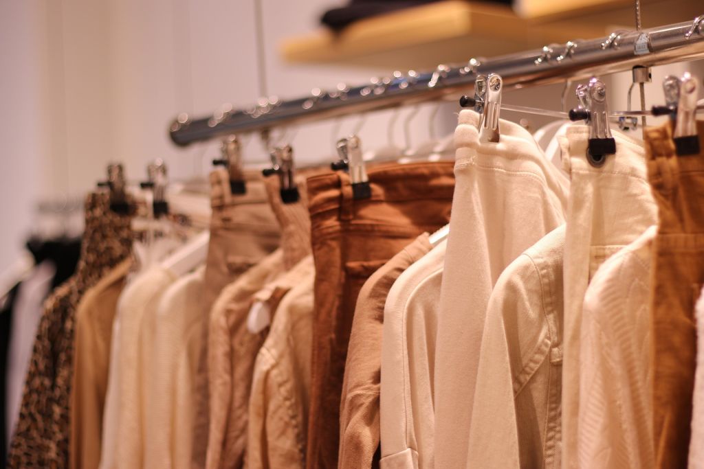 Different types of clothes hanging on a rack 